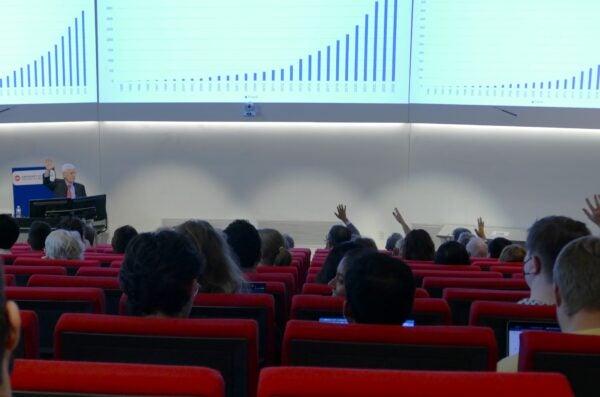 Hands raised in a lecture